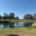 Panoramic view of a lush green golf course at Quixote Club. Smooth