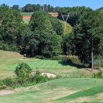 Panoramic view of a lush green golf course at RTJ Golf Trail at Oxmoor Valley. Smooth