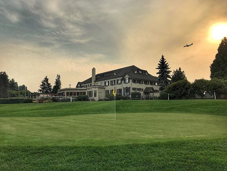 Panoramic view of a lush green golf course at Rainier Golf and Country Club. Smooth