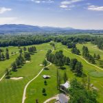 Panoramic view of a lush green golf course at Ralph Myhre Golf Course. Smooth