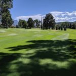 Panoramic view of a lush green golf course at Ranch At Roaring Fork Golf Course. Smooth