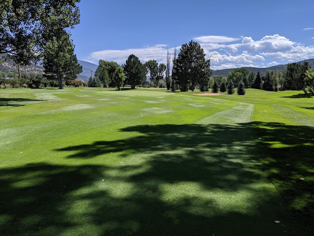 Panoramic view of a lush green golf course at Ranch At Roaring Fork Golf Course. Smooth