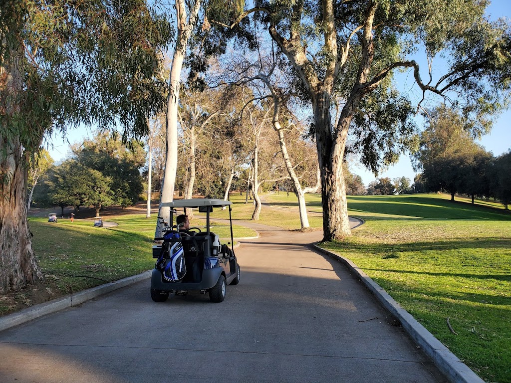 Panoramic view of a lush green golf course at Rancho Park Golf Academy. Smooth