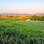 Panoramic view of a lush green golf course at Rancho Vista Golf Course. Smooth