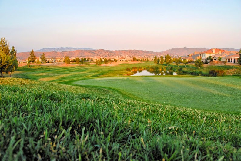 Panoramic view of a lush green golf course at Rancho Vista Golf Course. Smooth