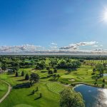 Panoramic view of a lush green golf course at Randall Oaks Golf Club & Banquets. Smooth