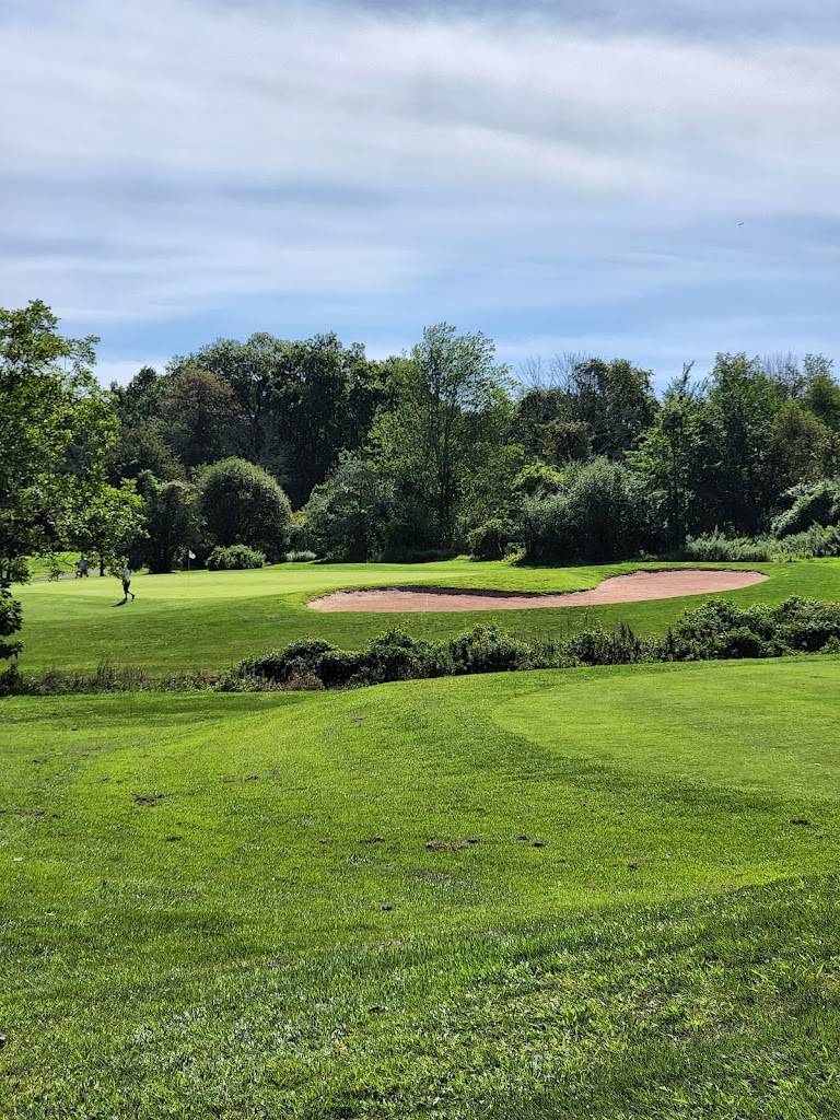 Panoramic view of a lush green golf course at Raritan Landing Golf Course. Smooth