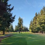 Panoramic view of a lush green golf course at Raspberry Ridge Golf Course. Smooth