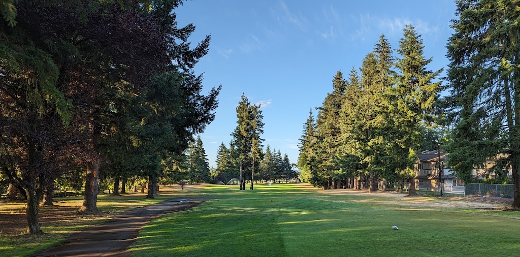 Panoramic view of a lush green golf course at Raspberry Ridge Golf Course. Smooth