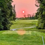 Panoramic view of a lush green golf course at Raven's Claw Golf Club. Smooth