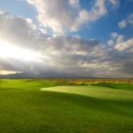 Panoramic view of a lush green golf course at Red Hawk Golf Club. Smooth