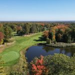 Panoramic view of a lush green golf course at Red Hawk Golf Course. Smooth