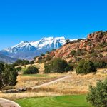 Panoramic view of a lush green golf course at Red Ledges. Smooth