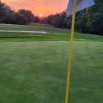 green grass with the flag in the hole.