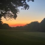 Panoramic view of a lush green golf course at Red Oak Country Club. Smooth