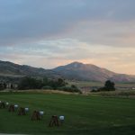 Panoramic view of a lush green golf course at Red Rocks Country Club. Smooth