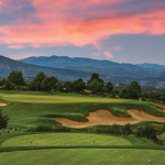 Panoramic view of a lush green golf course at Red Sky Golf Club. Smooth