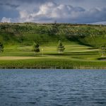 Panoramic view of a lush green golf course at RedHawk Public Golf Course. Smooth