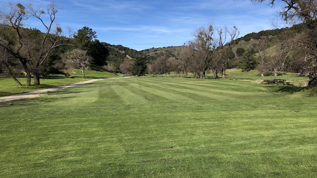 Panoramic view of a lush green golf course at Redwood Canyon Golf Course. Smooth