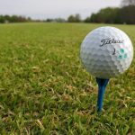 green grass with the flag in the hole.
