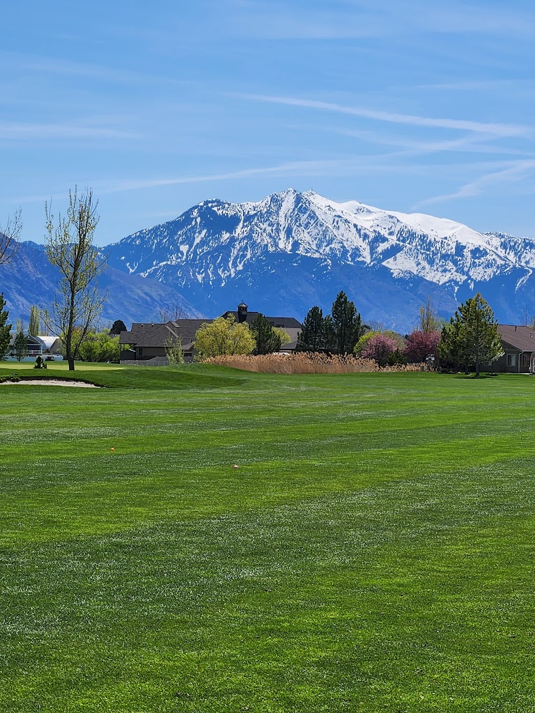 Panoramic view of a lush green golf course at Remuda Golf Course and Driving Range. Smooth