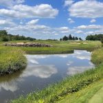 Panoramic view of a lush green golf course at Rich Harvest Farms. Smooth