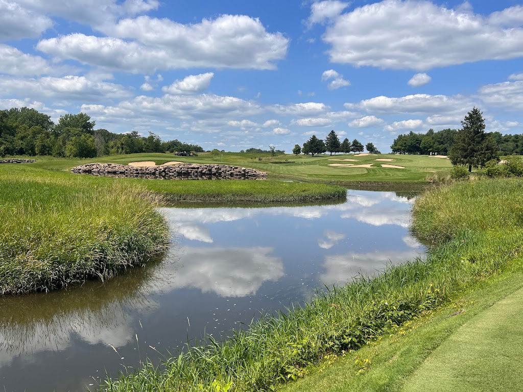 Panoramic view of a lush green golf course at Rich Harvest Farms. Smooth