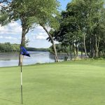 green grass with the flag in the hole.