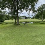 Panoramic view of a lush green golf course at Ridder Farm Golf Course. Smooth
