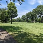 Panoramic view of a lush green golf course at Ridge CC Golf Course. Smooth