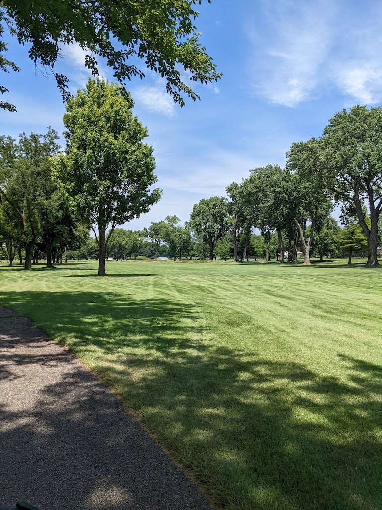 Panoramic view of a lush green golf course at Ridge CC Golf Course. Smooth