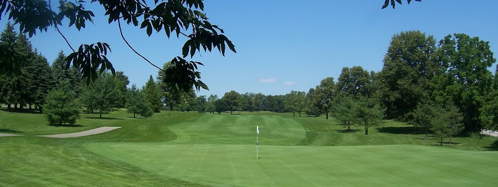 Panoramic view of a lush green golf course at Ridge Top Golf Course. Smooth