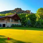 Panoramic view of a lush green golf course at Rifle Creek Golf Course. Smooth