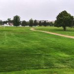 Panoramic view of a lush green golf course at River Bend Golf Course. Smooth