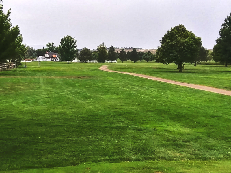 Panoramic view of a lush green golf course at River Bend Golf Course. Smooth