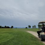 green grass with the flag in the hole.