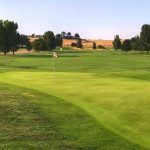 Panoramic view of a lush green golf course at River Birch Golf Course. Smooth