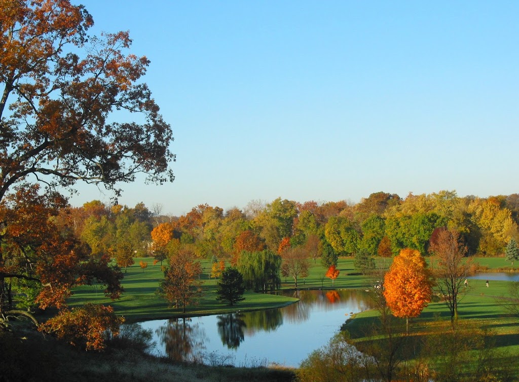 Panoramic view of a lush green golf course at River Glen Country Club. Smooth