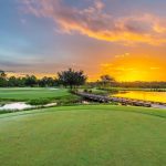 Panoramic view of a lush green golf course at River Hall Country Club. Smooth