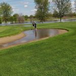 Panoramic view of a lush green golf course at River Heights Golf Course. Smooth