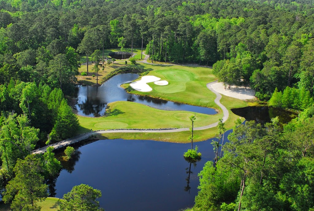 Panoramic view of a lush green golf course at River Hills Golf & Country Club. Smooth