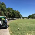 Panoramic view of a lush green golf course at River Isles Golf Club. Smooth
