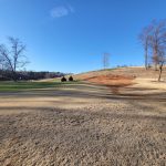 Panoramic view of a lush green golf course at River Oaks Golf Club. Smooth