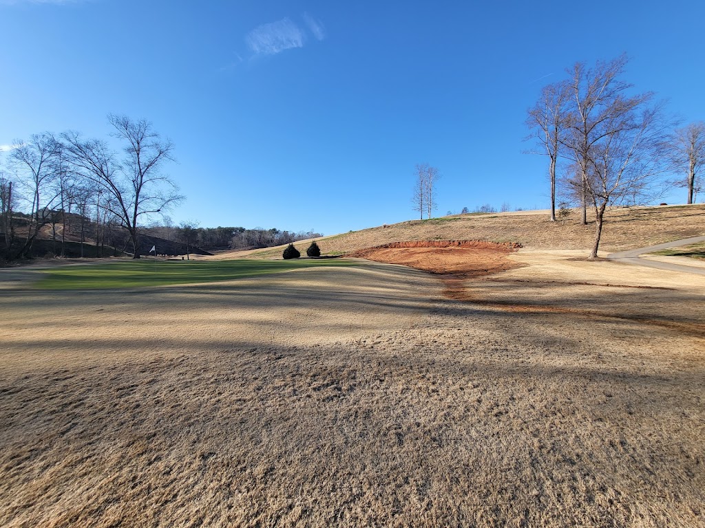 Panoramic view of a lush green golf course at River Oaks Golf Club. Smooth