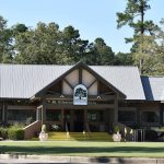 Panoramic view of a lush green golf course at River Oaks Golf Club. Smooth