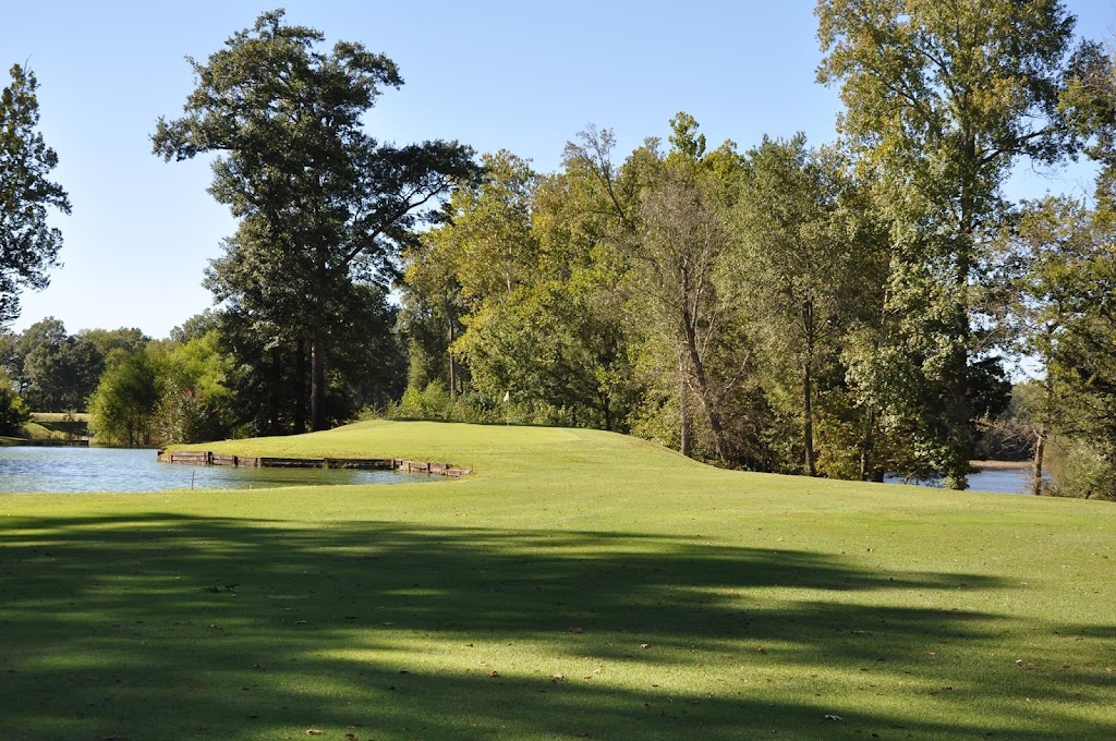 Panoramic view of a lush green golf course at River Oaks Golf Club. Smooth