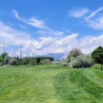 Panoramic view of a lush green golf course at River Oaks Golf Course. Smooth