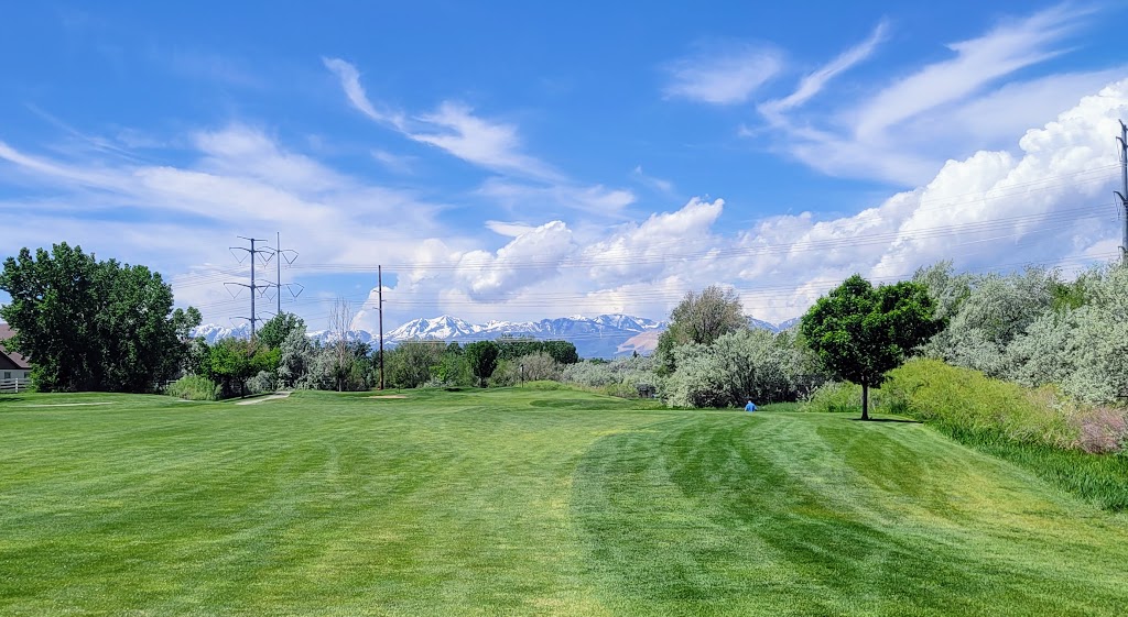 Panoramic view of a lush green golf course at River Oaks Golf Course. Smooth