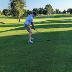 green grass with the flag in the hole.