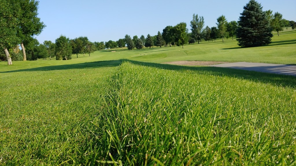Panoramic view of a lush green golf course at River Ridge Golf Course. Smooth